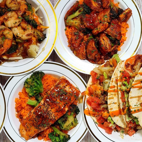 Four plates of American cuisine, including shrimp, chicken, salmon with rice and broccoli, and tacos.
